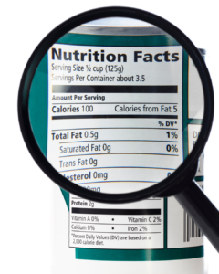 Person checking a food label carefully to manage dietary sensitivities and avoid hidden gluten.