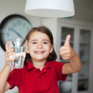 Young woman drinking a glass of water