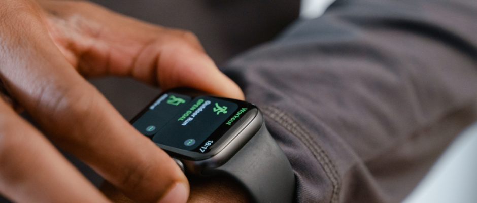 Person setting daily goals on smartwatch for wearable fitness preventive care, tracking steps and heart rate