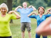 Group of diverse seniors engaging in outdoor exercise in a park.
