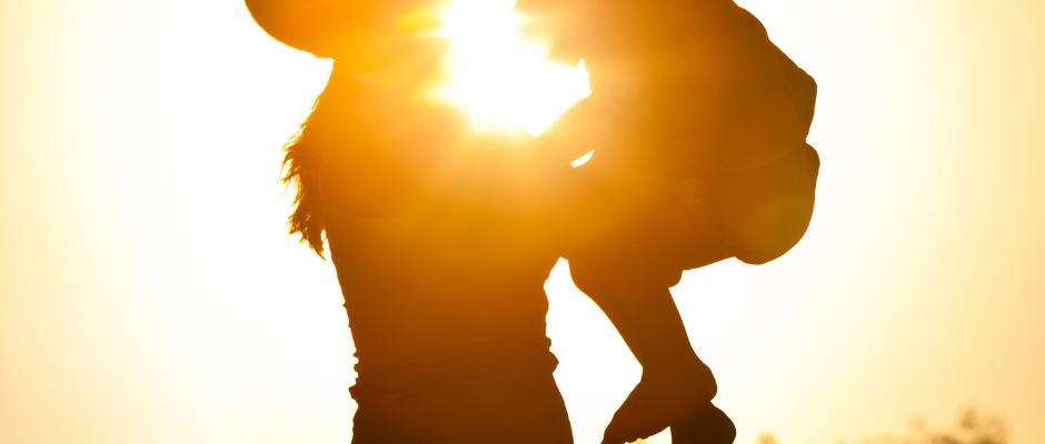 A mother gently cradling her baby, emphasizing self-care and personal well-being.